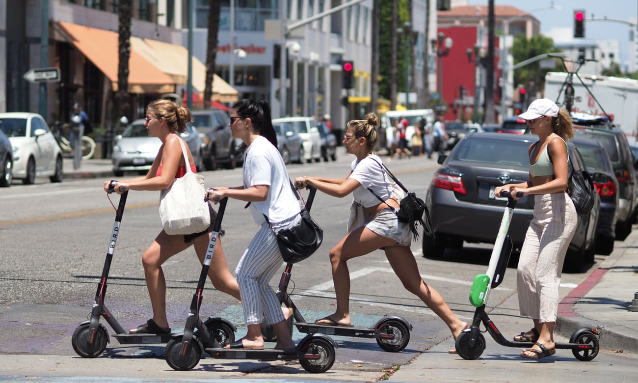 People ride e-scooters in Santa Monica, California.