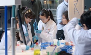 Kids in lab coats at the centre’s Experiment Zone, where you can carry out hands-on experiments.