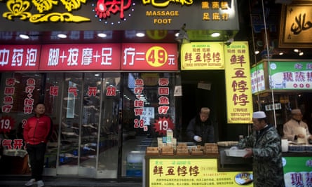 A foot massage shop and a halal food stall in Xiyangshi Street.