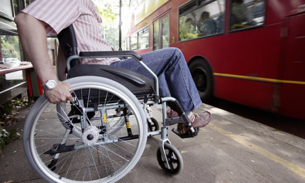Disabled man in wheelchair getting on bus.