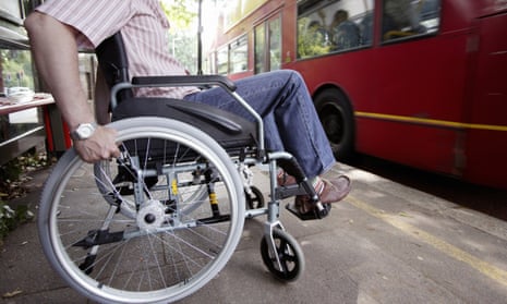 Disabled man in wheelchair at bus stop