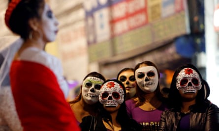 Women wear skeleton masks during a procession organized by sex workers to remember their deceased colleagues ahead of the Day of the Dead parade