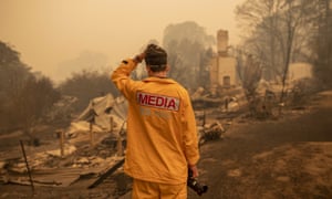 ABC photographer Matt Roberts reacts to seeing his sister’s house destroyed by a bushfire in Quaama, NSW, on 1 January.