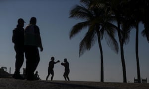 People exercise on the first day of beaches reopening in Rio de Janeiro, Brazil, on 2 June.
