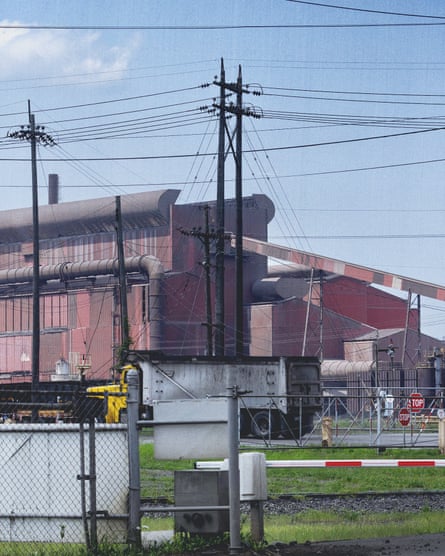An outside look of a steel plant surrounded by fencing