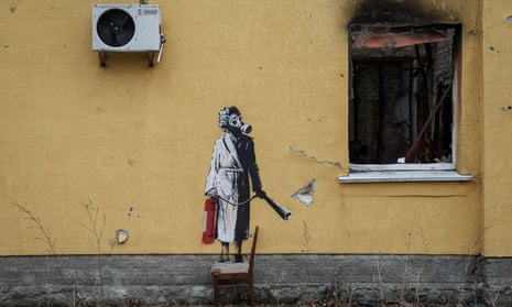 A Banksy mural of a person wearing a nightgown and holding a fire extinguisher, next to the charred remains of a window
