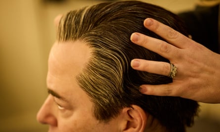 A stylist works on Broderick’s hair