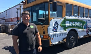 Ors Csaszar, of One Planet Recycling, poses with the bus he uses to ferry recyclers from San Francisco’s Chinatown.