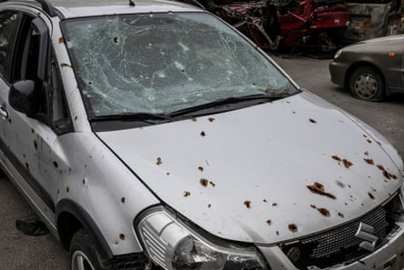 Civilian cars in Irpin riddled with bullet holes.