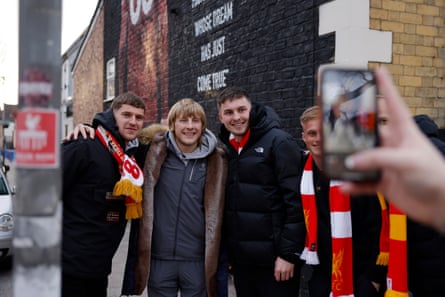Paddy poses for a photo with fans outside Anfield.