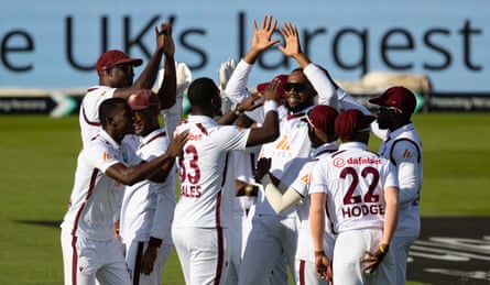 Jayden Seales (No 33) celebrates with his teammates after taking the wicket of Mark Wood.