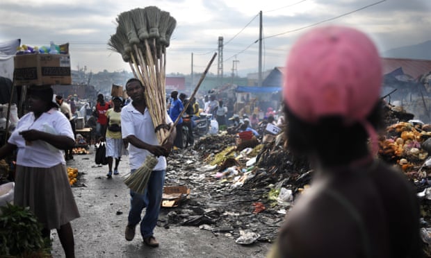 A man sells brooms at a market in Port-au-Prince.