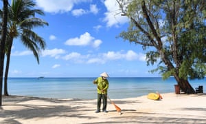A staff member sweeps the grounds of the Vinpearl resort on Phu Quoc island on Friday as the island prepared for its first international tourists to arrive in almost two years.