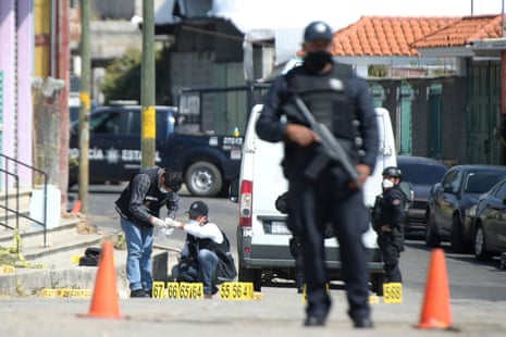 Police officers work at a crime scene where gunmen killed at least 13 Mexican police officers in an ambush, in Coatepec Harinas.