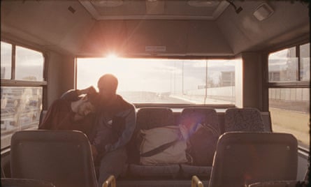 two people sit in the back of a vehicle