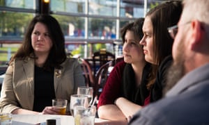 Deanna Fox, 30 (from left), Jennifer Van Iderstyne, 35, Emily Lemieux, 34, and Jeff Cutler, 42, listen during a conversation about the presidential election on 9 May 2016 in Albany, New York. Photograph: Bastien Inzaurralde for the Guardian