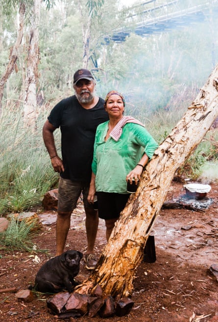 Lorraine Coppin, Michael Woodley standing in the bush with one of their dogs