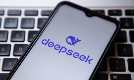 The DeepSeek logo on a phone placed on a keyboard.