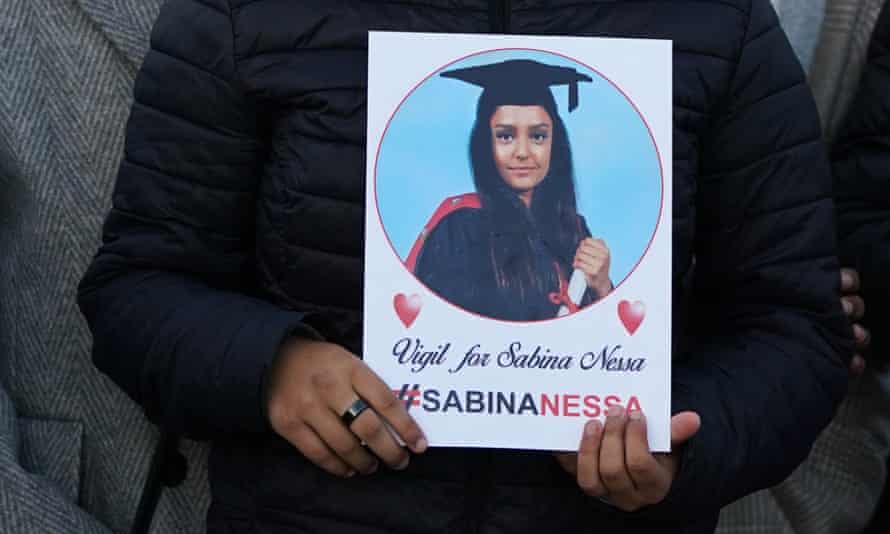 A person holding a picture of Sabina Nessa at a vigil last year.