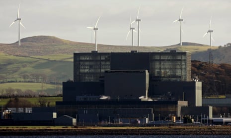 A windfarm on the hills behind Hunterston nuclear power station