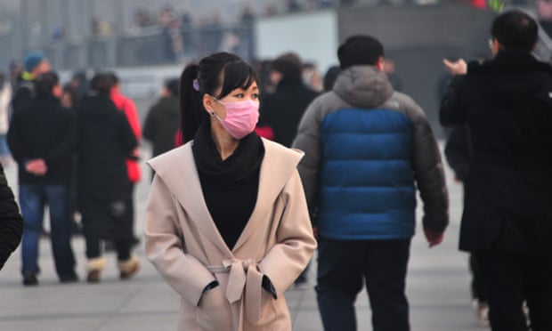 A woman covers her face during heavy pollution in Shanghai, China.