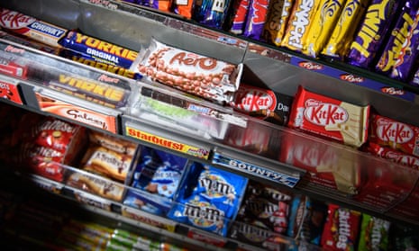 Various chocolate bars on a newsagent's shelves