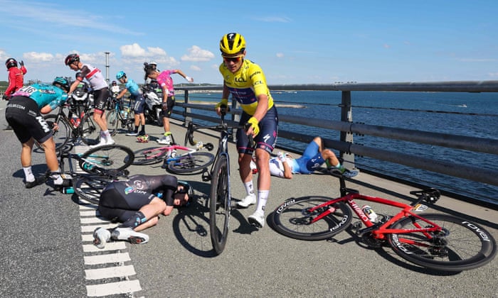 Yves Lampaert gets back on his bike after crashing on the bridge.