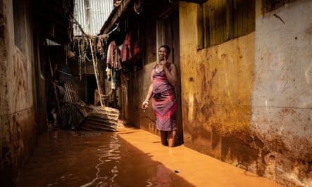 Jane Kalekye stands outside her home in the Mathare slum in Nairobi, which has been flooded almost every night as El Niño rains devastate Kenya.