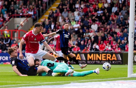 Middlesbrough’s Tommy Conway (left) prods the ball home to open the scoring at Wrexham.