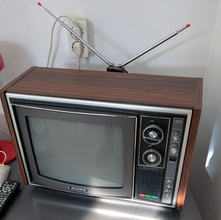 A TV with a wooden surround, a control panel to the right of the screen and a V-shaped aerial sticking up at the back.