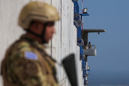 soldiers guard an entrance to a prison