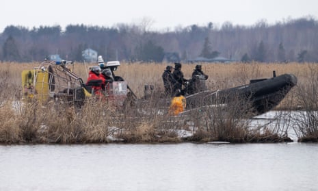 Searchers look for victims in Akwesasne, Quebec, after the bodies of eight migrants were pulled from a river that straddles the Canada-US border.