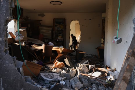 A resident inspects the family home in Zarzir after the Iranian missile strike