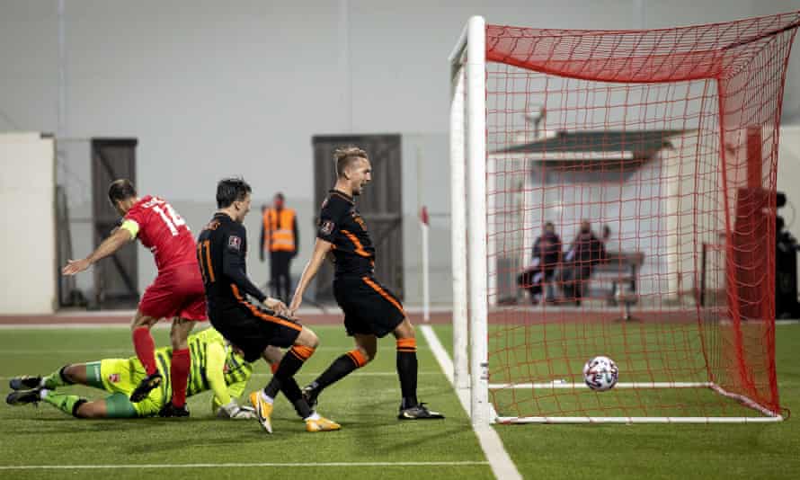 Roy Chipolina and goalkeeper Dayle Coleing are beaten by Luuk de Jong.