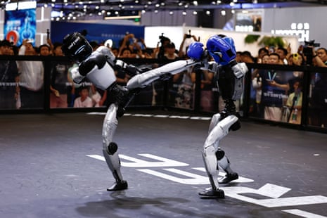 Humanoid robots by Unitree Robotics demonstrate kickboxing during the 2026 World Robot Conference, in Beijing on 19 August.