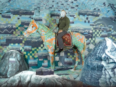 A man on a horse against a blue background