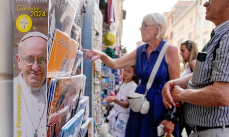Tourists look at items at a souvenir shop near the Vatican