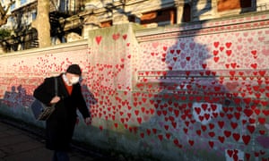 A man walks past the national Covid Memorial Wall on the south bank of the Thames River in London, Britain, on 13 January.