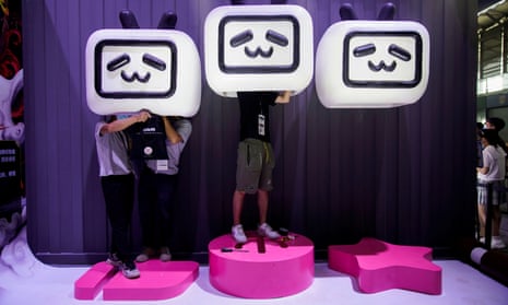 People install a cartoon decoration at the China Digital Entertainment Expo and Conference in Shanghai.  China is cracking down on its entertainment industry.