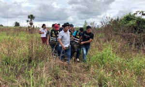 Police carry the body of Sebastian Woodroffe who was beaten and strangled in the jungle region of Ucayali in Peru.