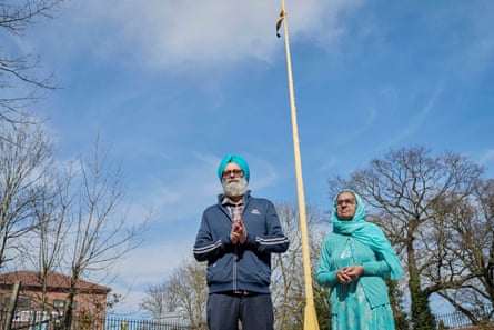 My parents in Slough outside their local temple, Ramgarhia Sikh gurdwara. Behind them is the sacred Khanda flag, a sign for all Sikhs and people from other faiths that they can come and pray in this building
