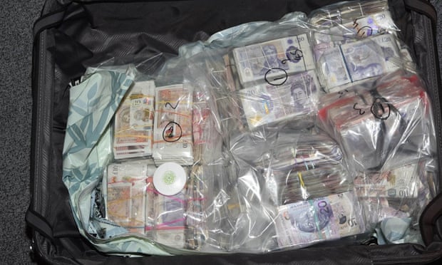 Pound notes in suitcase