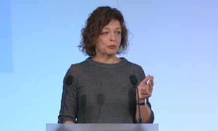 Julia Waters speaks at a lectern with a microphone