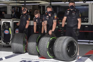 Red Bull technicians prepare the tires during the first practice session.