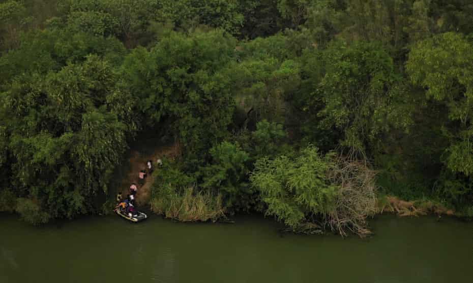 Migrants climb up the banks of the Rio Grande River. The charred corpses were found near a town across the Rio Grande from Texas.