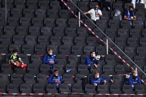 SC Paderborn squad members wearing protective face masks as they watch from the stands.