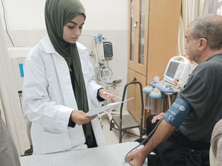 Medical student Aya Talb examining a patient in a hospital