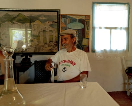 Vasilios sits at a kitchen table