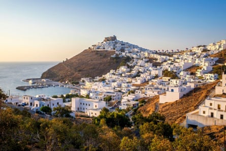 Whitewashed houses in a typical Greek island town by the sea.