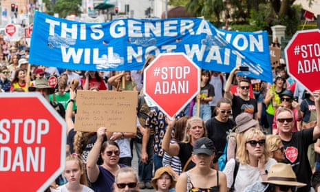 Marchers protest against Queensland’s controversial Adani coalmine. 